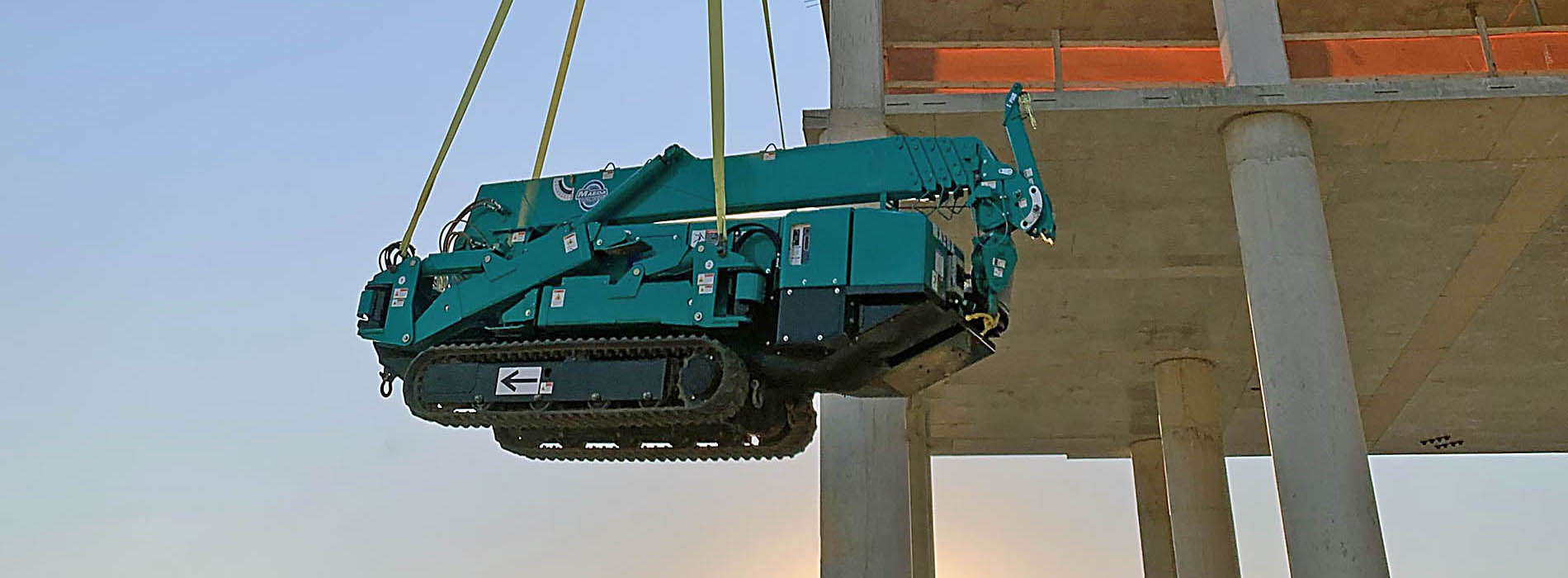 Elevación de una mini grúa MAEDA hasta lo alto de la construcción de un edificio
